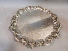 A collection of silver plate including a four footed repousse design tray, toast rack, swing