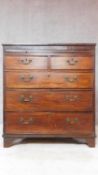 A Georgian mahogany and inlaid chest of two short over three long graduating drawers on bracket