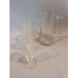 Three antique swirl hand blown wine glasses with polished pontil and a cut glass jug. Tallest 19cm.