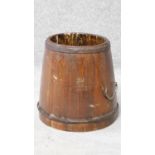 A 19th century wooden Chinese grain bucket with carved Chinese characters to the side. Brass handles