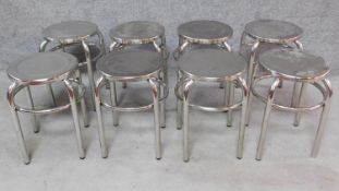 A set of eight low chrome stools. H.43cm