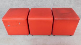 A set of three Johansen design cube footstools in red upholstery. H.44 W.42 D.42cm