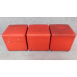 A set of three Johansen design cube footstools in red upholstery. H.44 W.42 D.42cm