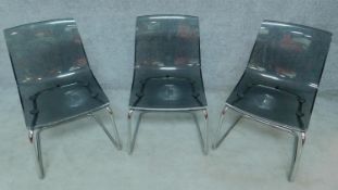 Three smoked grey moulded tub chairs on chrome base. H.83cm