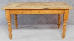 A pine planked top kitchen farmhouse table on turned tapering supports. H.78 W.152 D.81cm