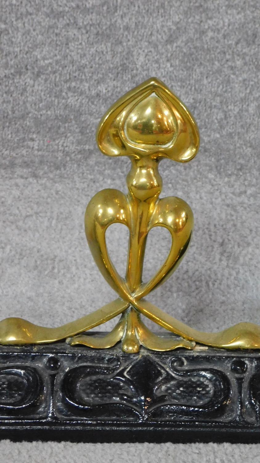 A late 19th century Art Nouveau brass and cast iron fender. W.129cm - Image 2 of 4