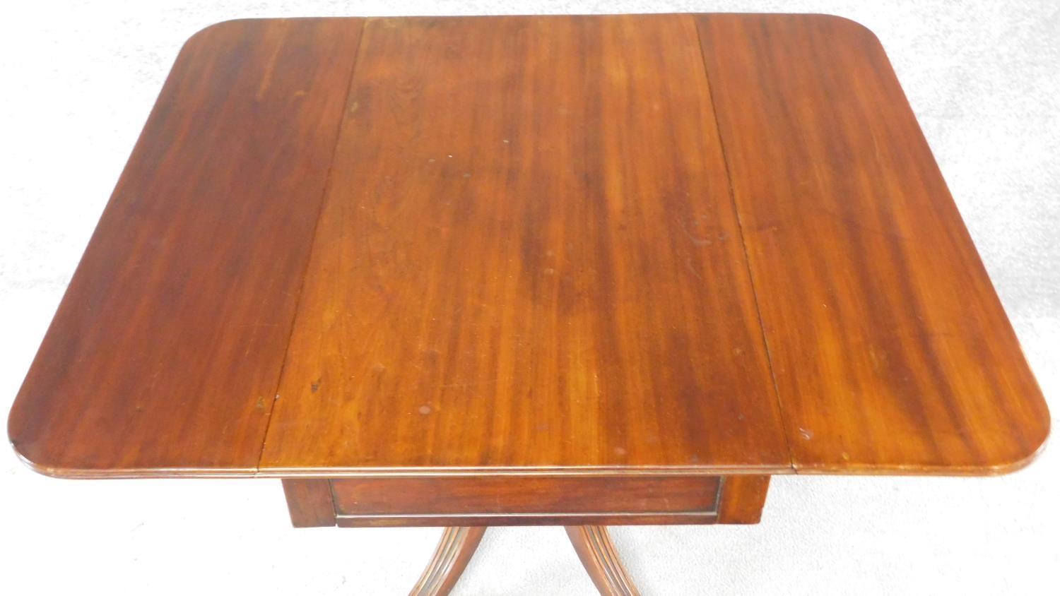 A Regency mahogany drop flap Pembroke table fitted end drawer on swept fluted quadruped supports. - Image 4 of 8