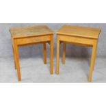 A pair of mid 20th century beech school desks with hinged sloped tops. H.76 W.62 D.46cm