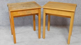 A pair of mid 20th century beech school desks with hinged sloped tops. H.76 W.62 D.46cm