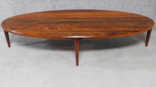 A large oval mid 20th century Danish rosewood coffee table. H.40 W.188 D.84cm