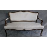 A French style carved frame canape in ivory damask upholstery on cabriole supports. H.95 W.150 D.