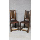 A pair of Carolean style oak hall chairs with linenfold carving to backs. H.103cm