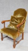 An antique style oak framed open armchair. H.102cm