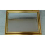 A rectangular gilt framed wall mirror fitted bevelled plate. 76x106cm
