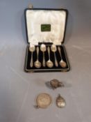 A cased set of six silver coffee spoons, hallmarked: Birmingham, 1934, a metal chick with engraved