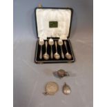 A cased set of six silver coffee spoons, hallmarked: Birmingham, 1934, a metal chick with engraved