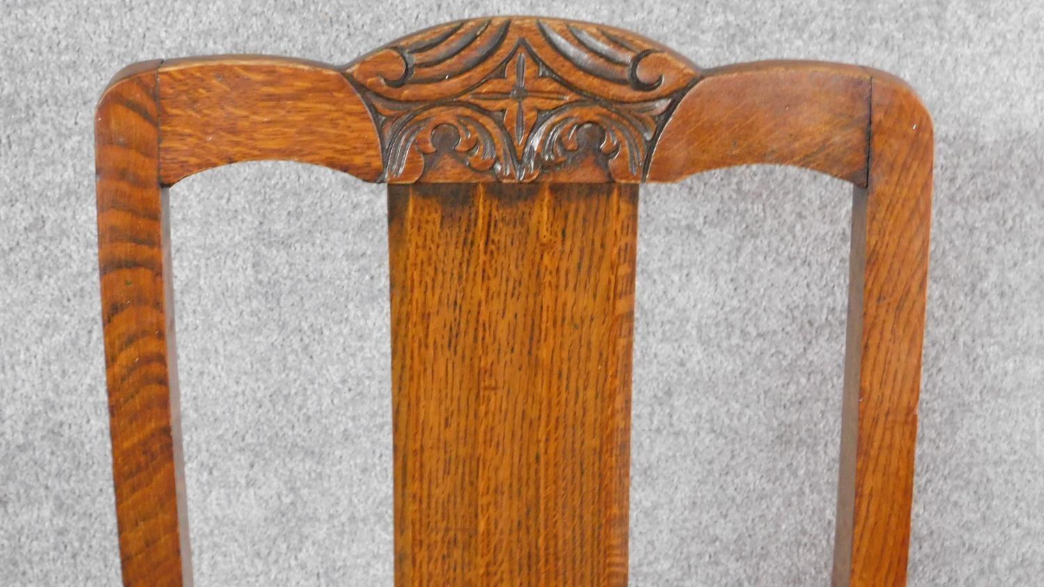 A set of four mid 20th century oak dining chairs with carved cresting in the Jacobean style. H.87cm - Image 3 of 8