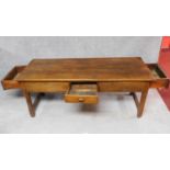 A large antique elm refectory dining table fitted two end drawers and a frieze drawer on square