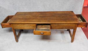 A large antique elm refectory dining table fitted two end drawers and a frieze drawer on square