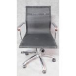An Eames style desk chair with black mesh seat and back on chrome base. H.90cm