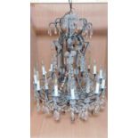 A twelve branch chandelier on a metal frame fitted with crystal swags and drops. H.92 W.75cm