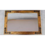 A contemporary eastern hardwood metal bound wall mirror. 92x61cm