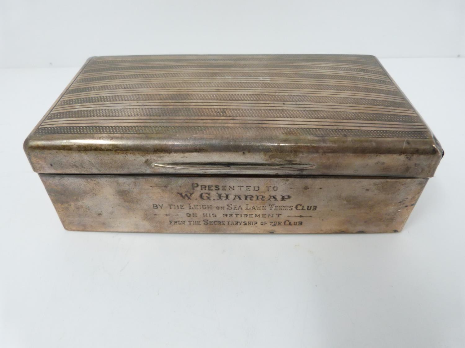 A silver cigarette box, cedar lined, London 1922, Alex Clark Ltd, inscribed with dedication.