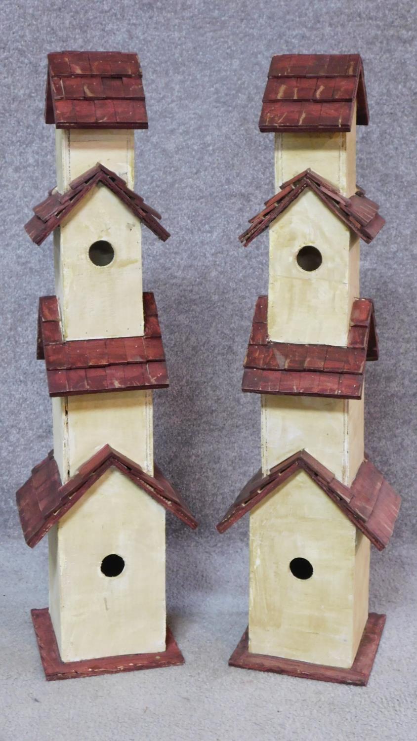 A pair of multi tiered bird houses. H.81cm