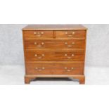 A Georgian mahogany chest of two short over three long drawers with crossbanded top on bracket feet.