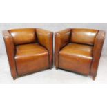 A pair of tan leather club armchairs on square supports. H.74 W.76 D.72cm