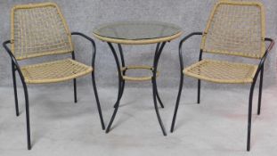 A wicker conservatory table with plate glass top and a pair of matching side chairs. H.69 W.60 D.