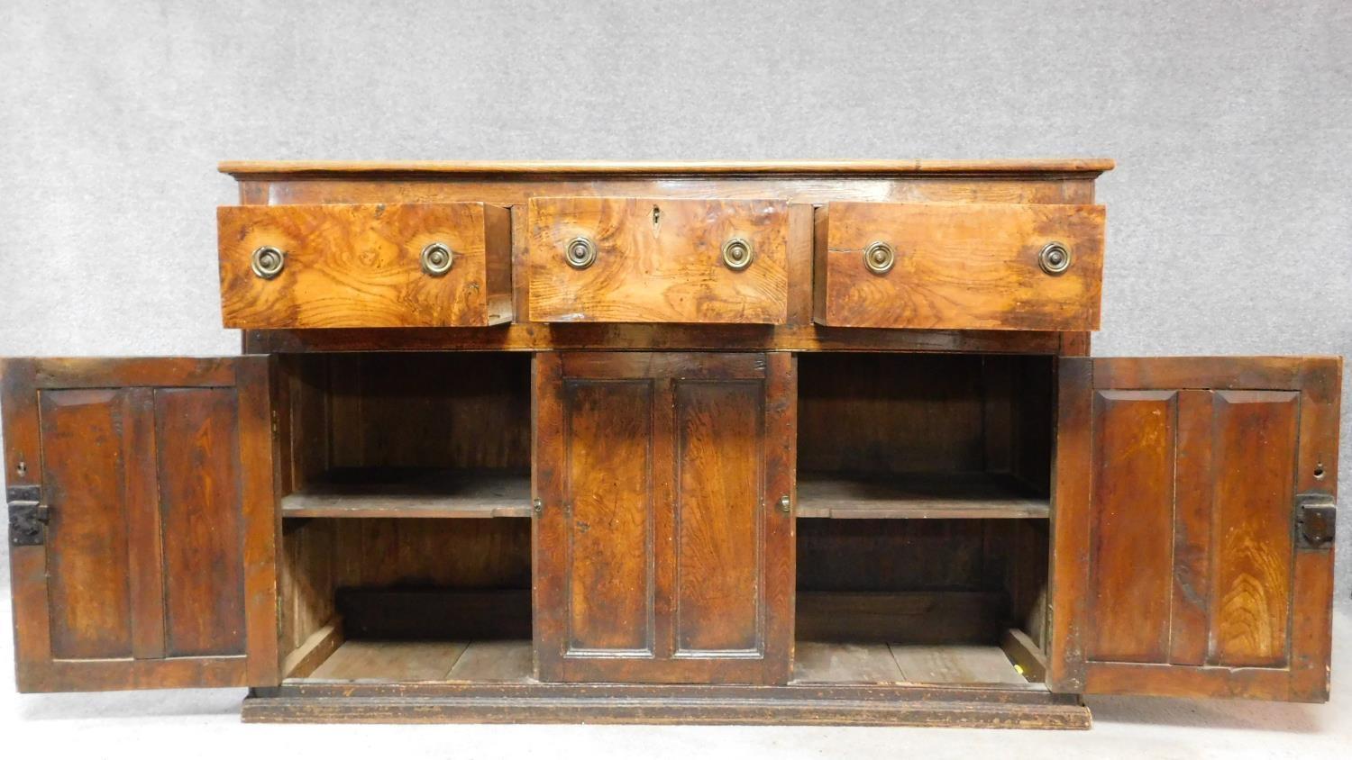 An antique country figured and burr elm dresser base fitted three frieze drawers above panel - Image 2 of 6