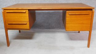 A mid 20th century teak Danflex twin pedestal desk, label to drawer. H.75 W.150 D.75cm