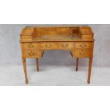 A Georgian style mahogany, crossbanded and satinwood line inlaid Carlton House desk with a galleried