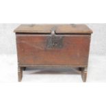 A small antique oak plank coffer with original hinges, clasp and lock with dentil carved top and