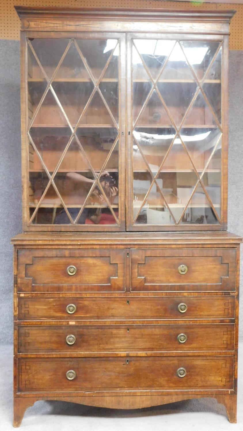 A late Georgian mahogany library bookcase with upper glazed section above fitted central