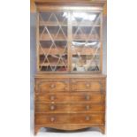 A late Georgian mahogany library bookcase with upper glazed section above fitted central