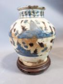 A middle eastern ceramic glazed vase on carved wooden Chinese stand. H23cm.