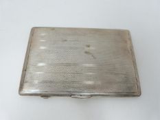 A rectangular engine turned decorated cigarette case, Birmingham, 1946, E J Houlston, engraved to