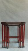 A nest of four Chinese style red lacquered graduating occasional tables on swept square section