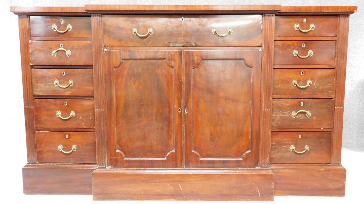 A late 19th century Georgian style breakfront sideboard with rosewood crossbanded top fitted central