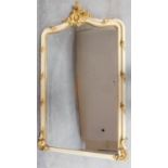 A late 19th century cream and carved giltwood Rococo style pier mirror with original shaped bevelled