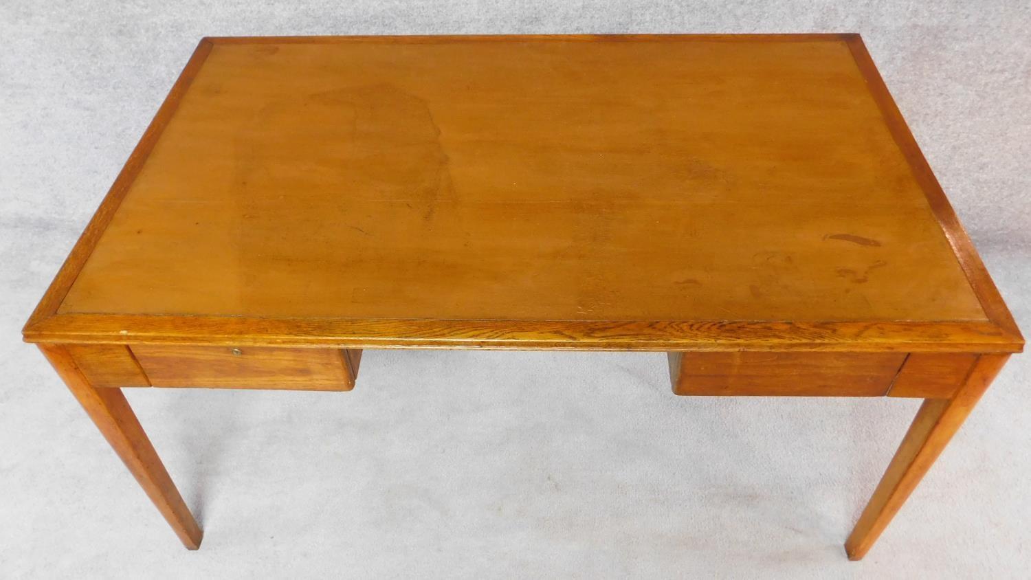 A mid 20th century oak two drawer writing table. H.76 W.152 D.91cm - Image 3 of 6