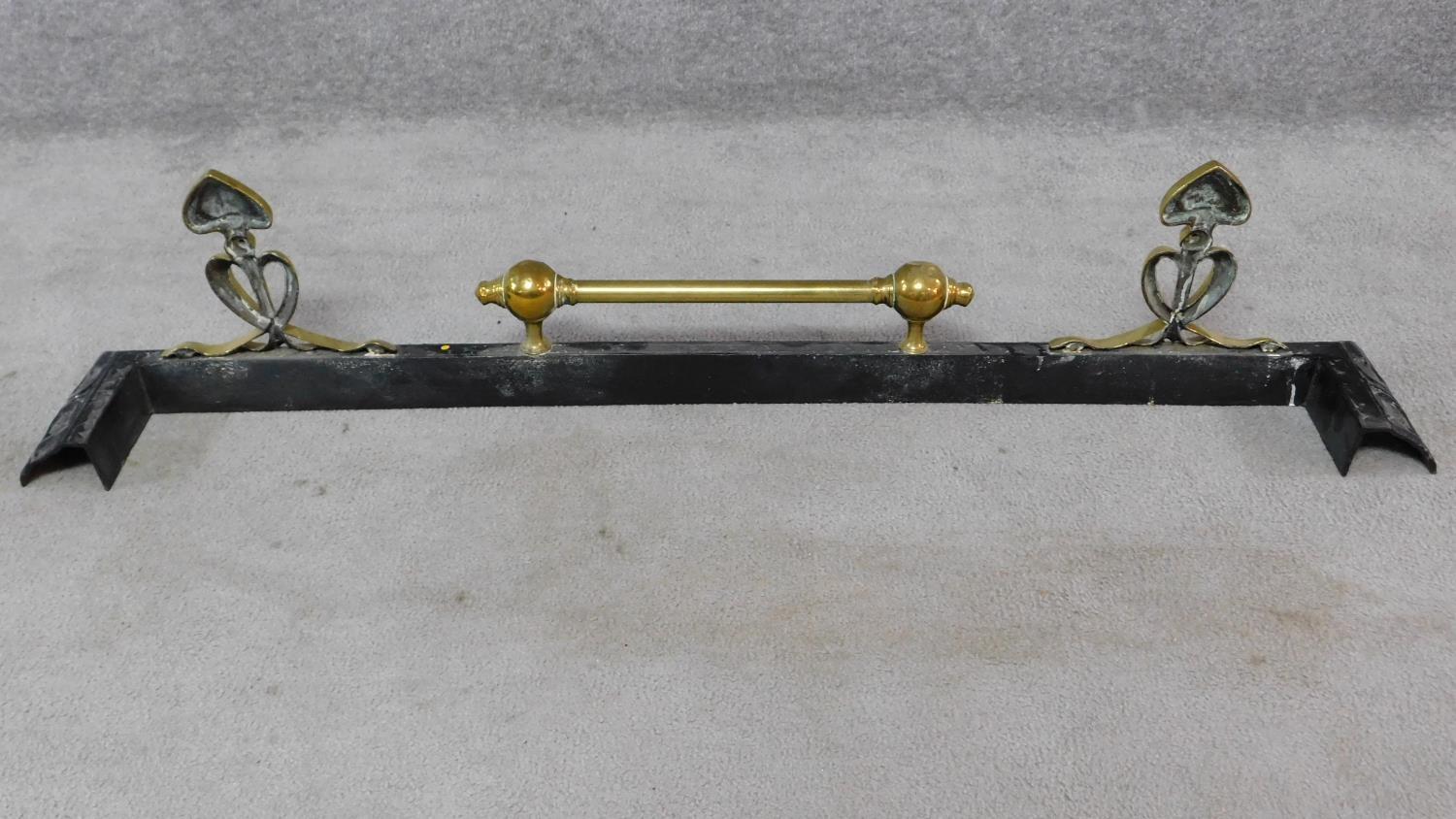 A late 19th century Art Nouveau brass and cast iron fender. W.129cm - Image 4 of 4