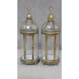 A pair of gilt metal framed storm lanterns with domed tops. H.79cm
