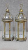 A pair of gilt metal framed storm lanterns with domed tops. H.79cm