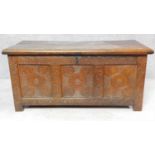 An antique oak coffer with carved frieze and panels fitted candle box on block feet. H.61 W.133 D.