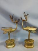 A pair of 19th century brass Chinese herons holding bamboo shoot candlesticks, with engraved