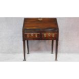 A Georgian mahogany bureau with fitted interior above two drawers with original handles on