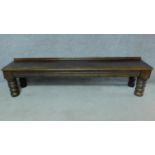 An oak hall bench on turned bulbous supports. H.44 W.187 D.40cm